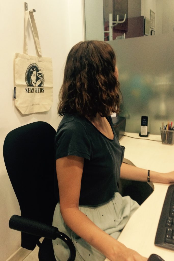 A woman sat at a desk in an office