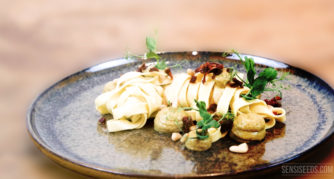 Tagliatelle with vegan pasta sauce and herbs on a plate