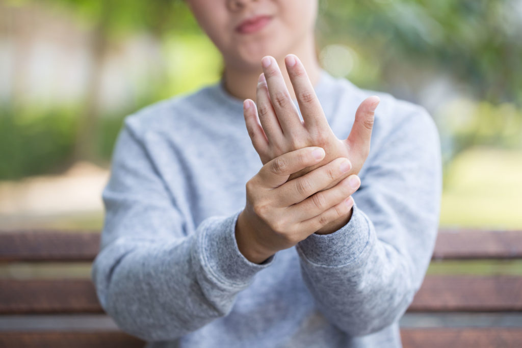 A woman holding her hand in front of her