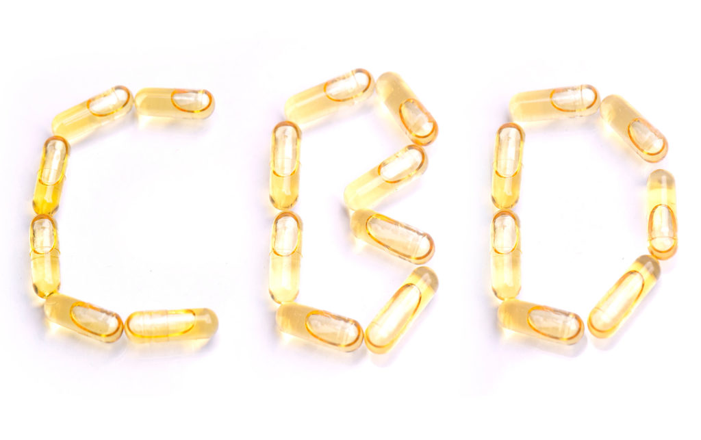 CBD capsules spelling out the word CBD