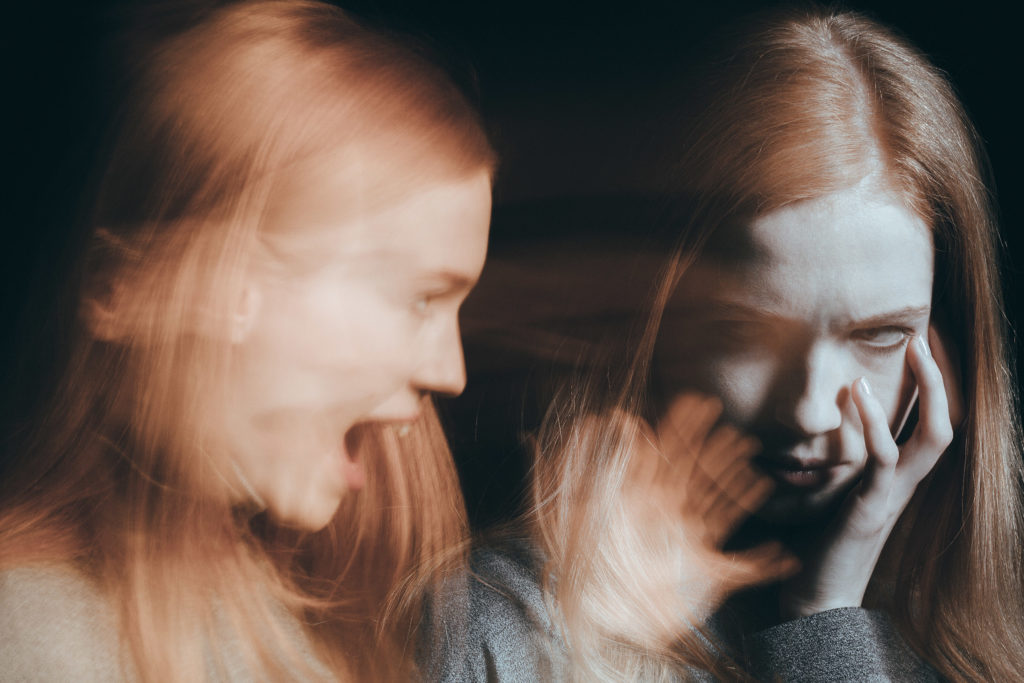 Blurred woman screaming while woman on the other side looks at it worried