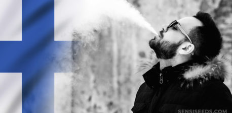 The Finnish flag and a man blowing out smoke from his mouth