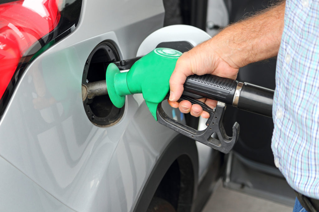 A man filing the gas in a car