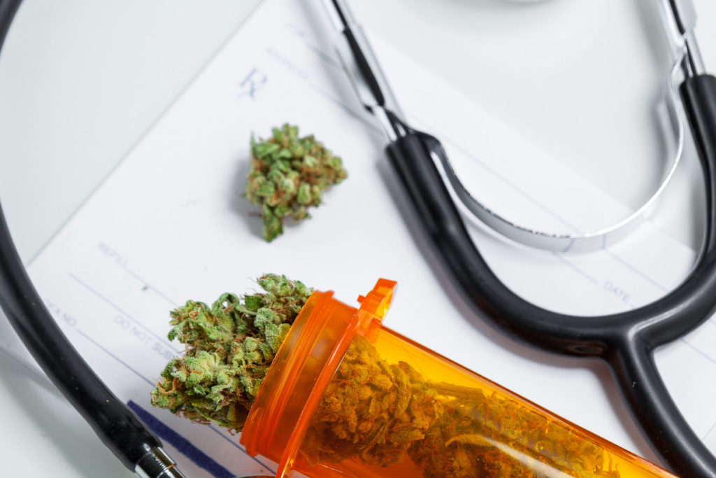 A stethoscope and an orange tube full of cannabis