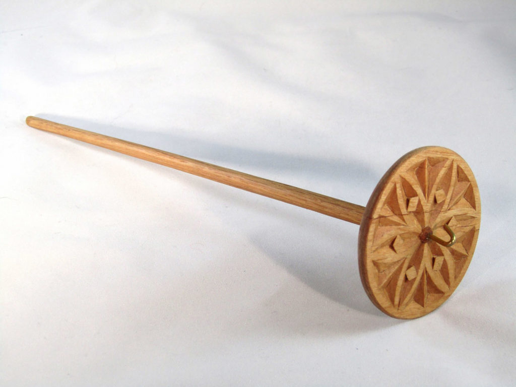 A carved wooden spindle against the white background