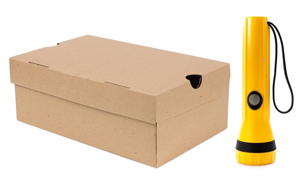 A shoebox and a torch against the white background