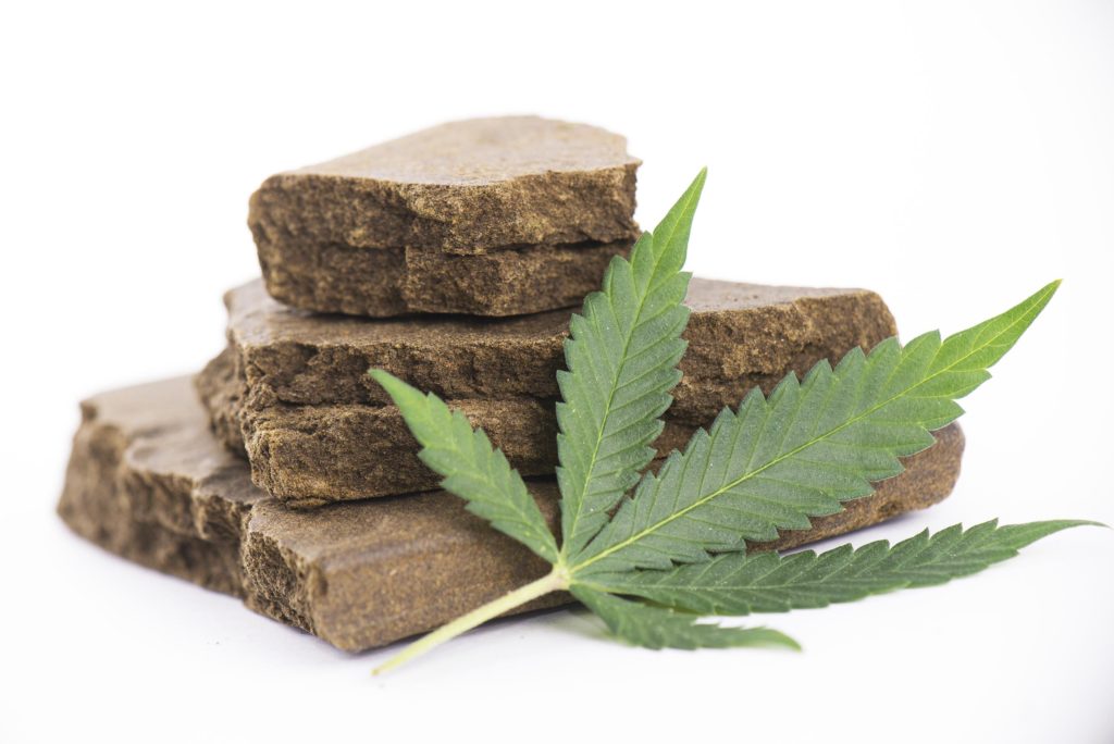 Different sizes of hash blocks and a cannabis leaf