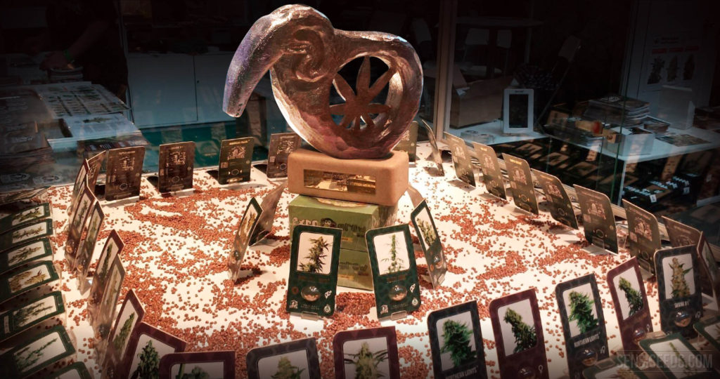 A display with cannabis products a statue with cannabis leaf