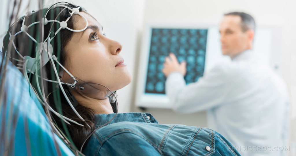 A doctor running a test on epilepsy on a woman