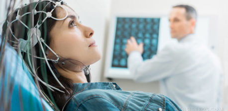 A doctor running a test on epilepsy on a woman