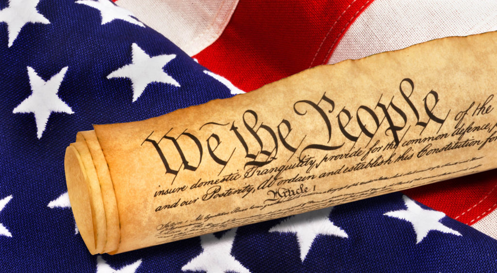 A stained roll of parchment resting on top of an American flag