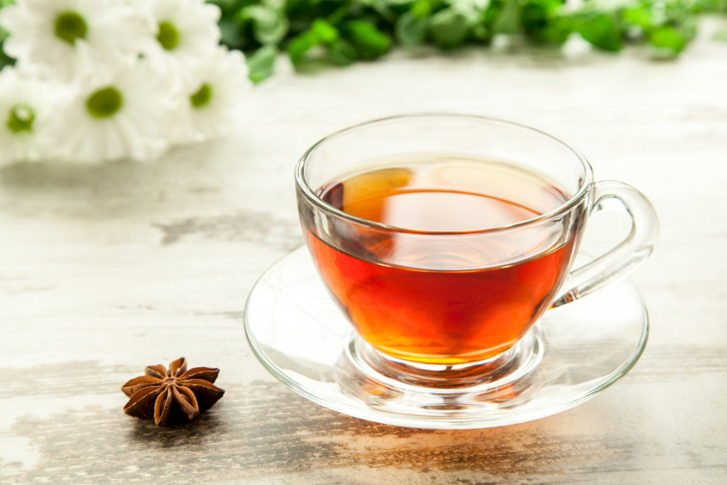 Cannabis root tea in a glass cup