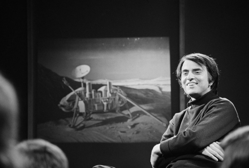 Carl Sagan giving a speech to an audience