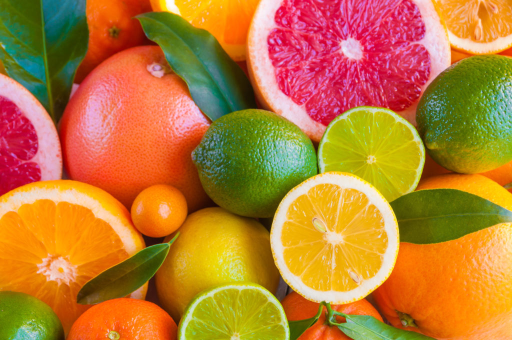 Various citrus fruits stacked together