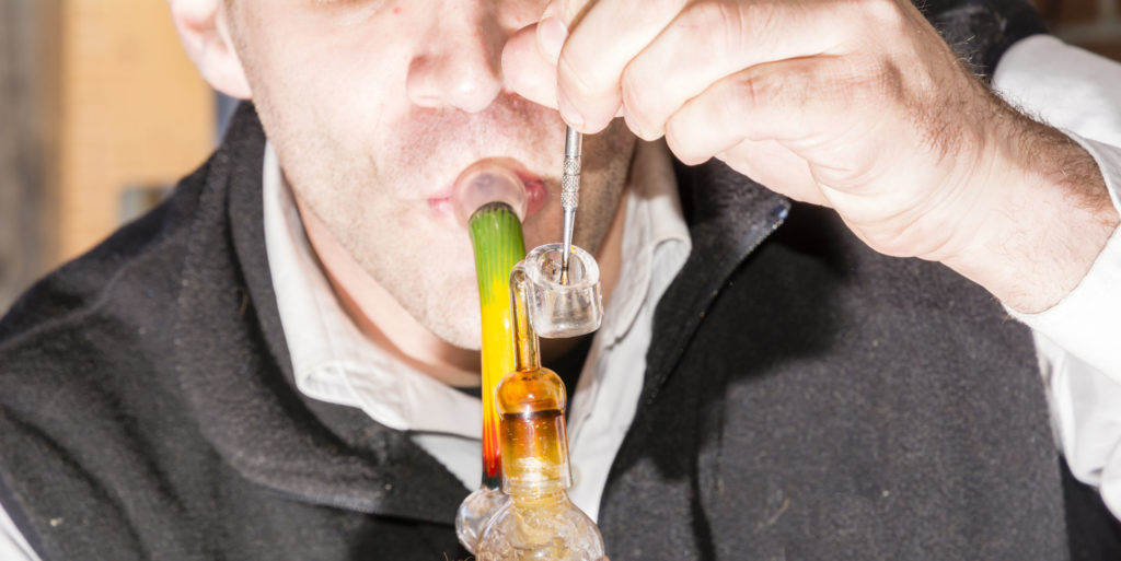 A man consuming rosin hash