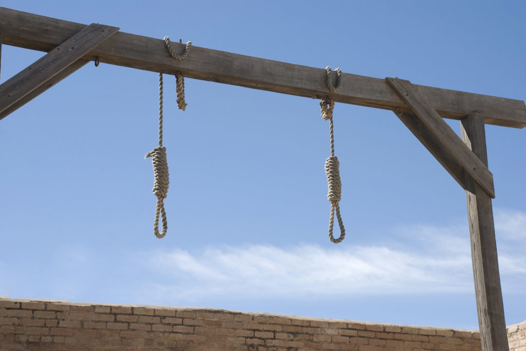 Two nooses hanging off a wooden beam