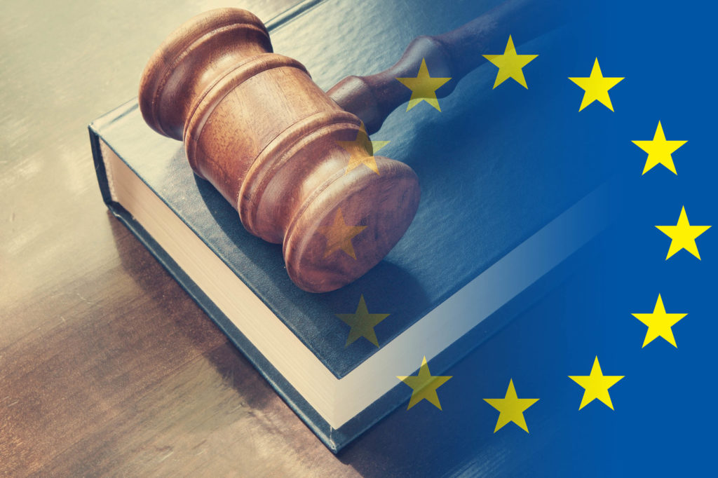 A European flag next to a gavel resting on a book