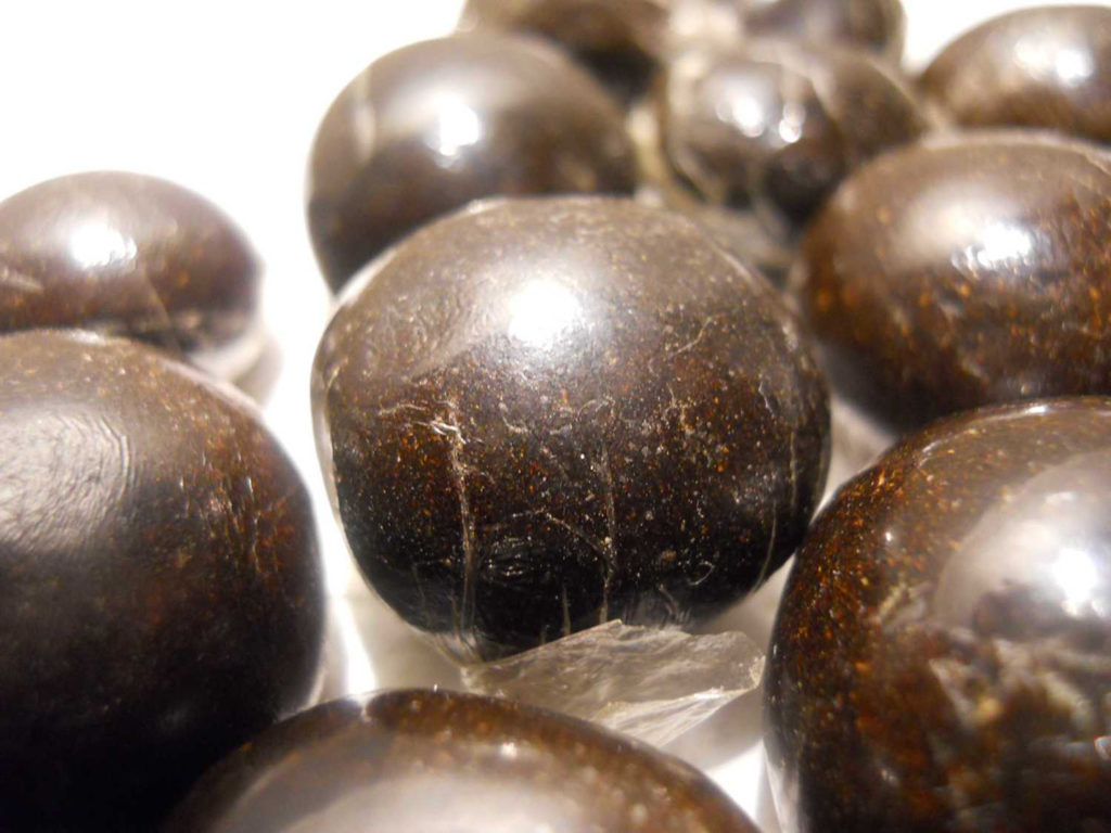 Hand-rubbed hashish bowls on a white surface