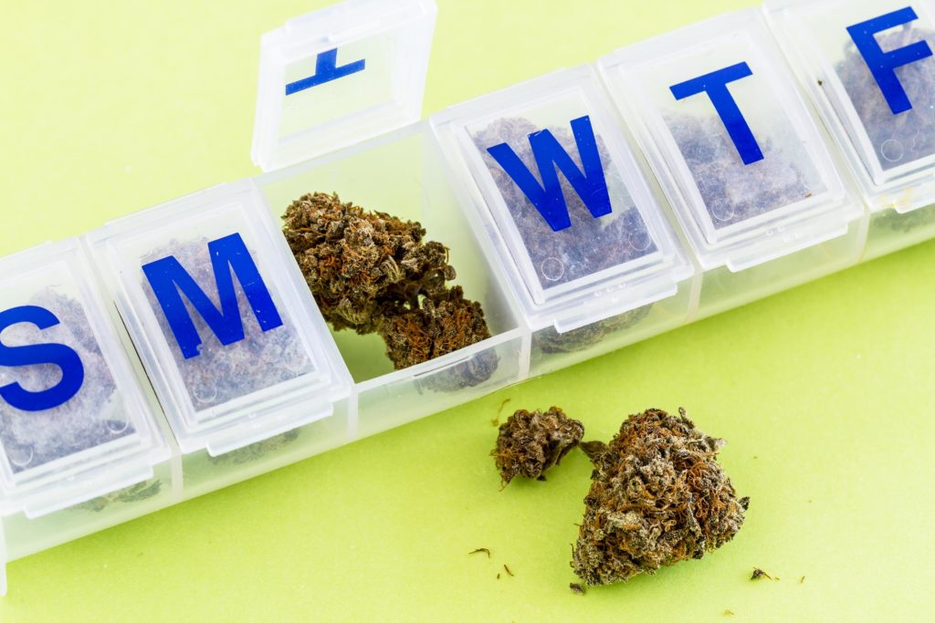 Medication container with cannabis buds