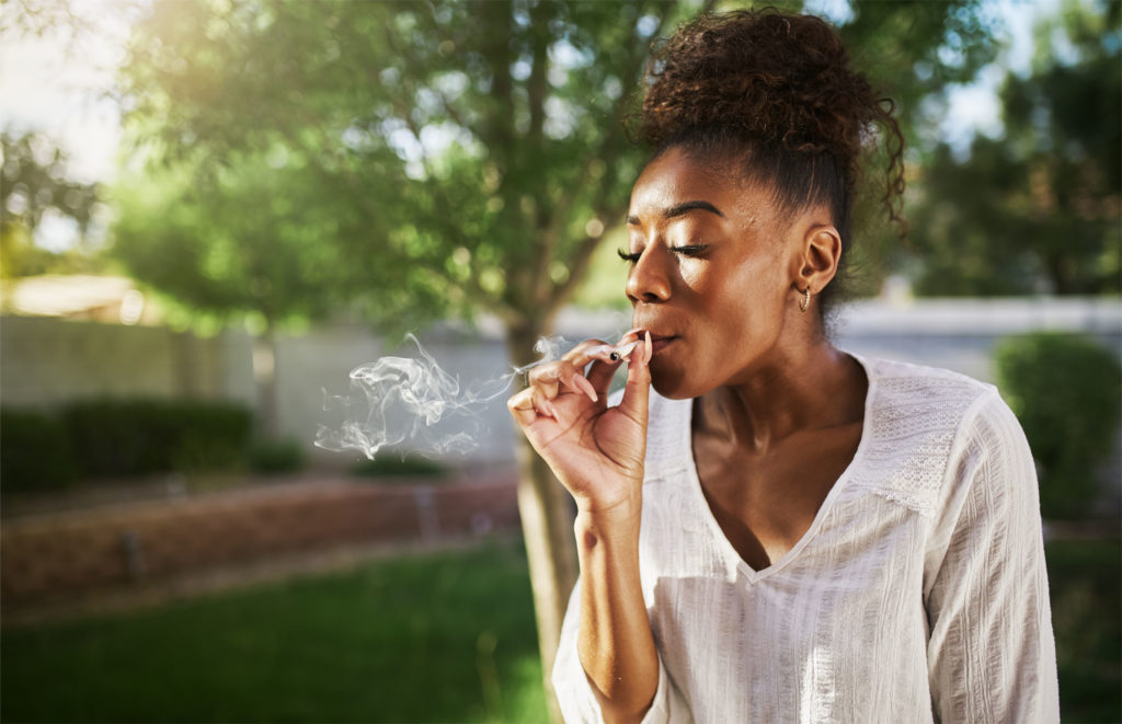 An African-American woman smoking a joint