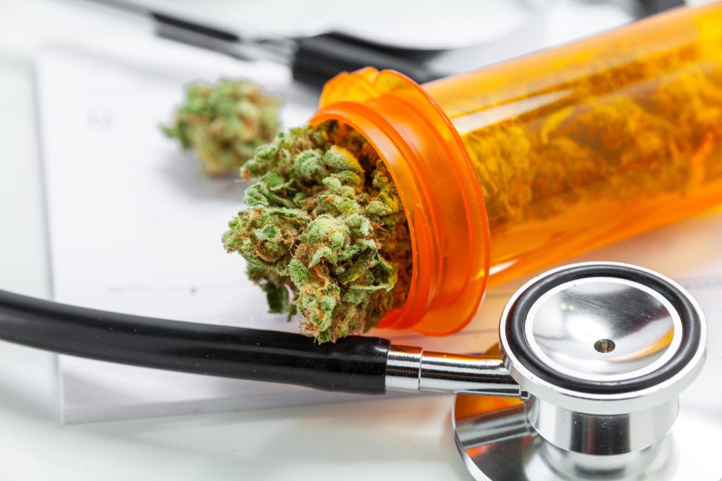 An orange tube of cannabis buds and a stethoscope