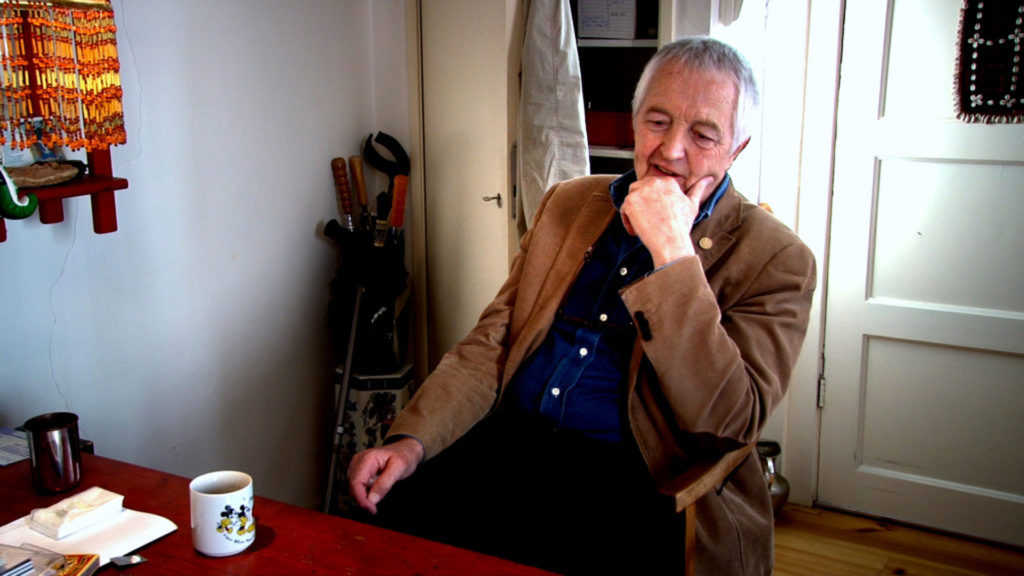 Henk Poncin sitting at the office table