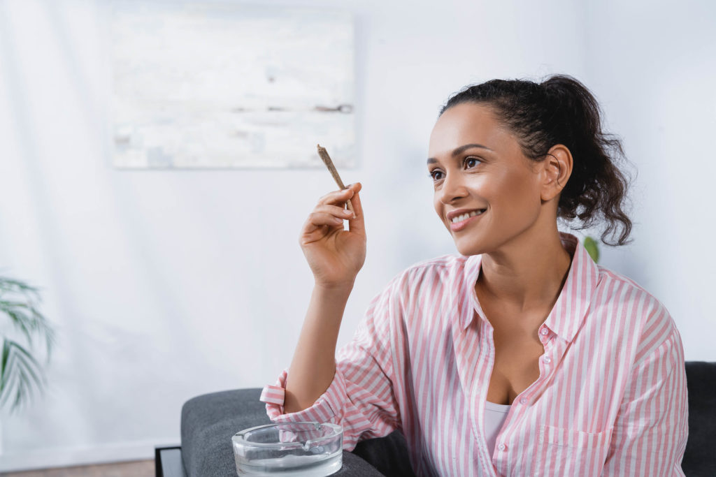 Brunette woman smoking a joint