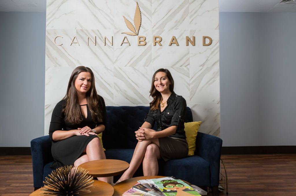 Olivia Mannix and Jennifer DeFalco with Canna Brand logo