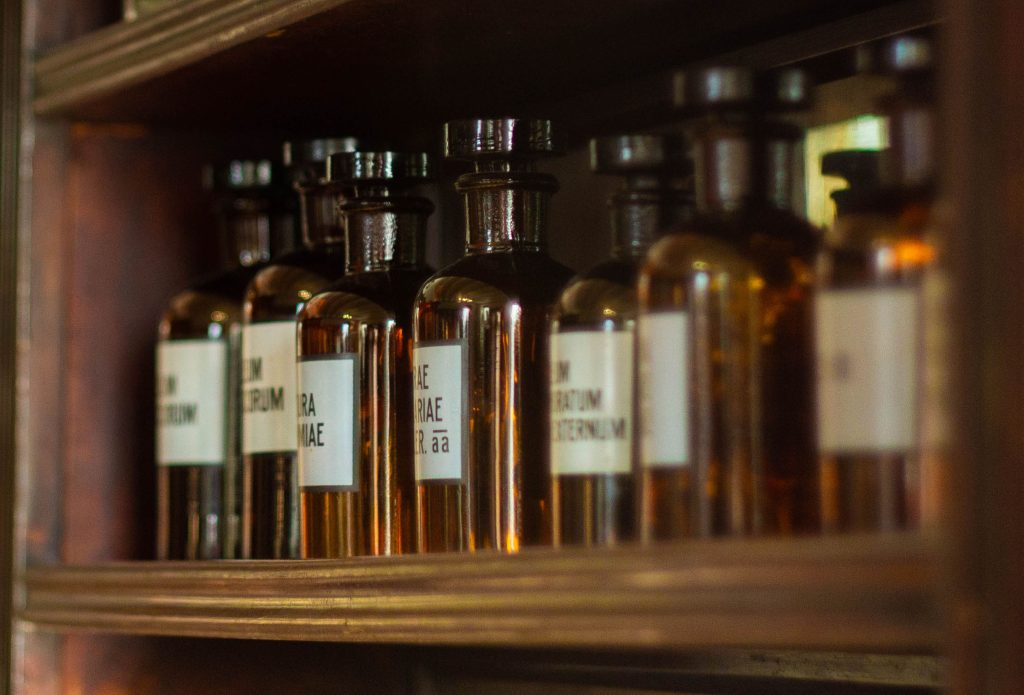 Cannabis tinctures in dark bottles stored on a wooden shelf